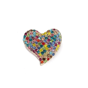 Vintage heart brooch with colorful rhinestones and gold alloy base on white background