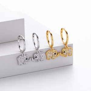 Macro shot of gold and silver S925 sterling silver elephant earrings with pavé zircon stones