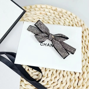 Close-up of elegant black bow hair clip with shimmering silver rhinestone inlay work