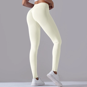 Detail of high waisted seamless yoga leggings with ribbed waistband in light yellow