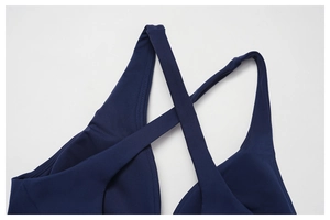 Detail of navy blue sports bra with stylish criss-cross back straps and sleek fabric