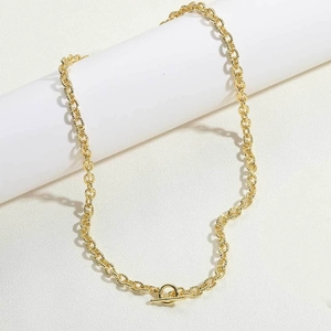 Close-up of 14K gold plated toggle clasp necklace with intricate engraved texture links