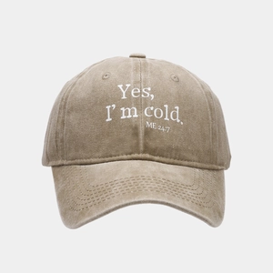 Detail of khaki washed cotton baseball cap featuring white Yes I'm cold printed text