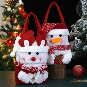 Christmas gift bag set with 3D snowman and reindeer designs in festive holiday setting