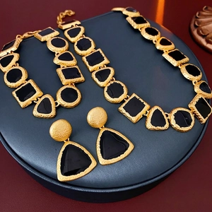 Vintage gold and black enamel geometric jewelry set with necklace, bracelet and earrings