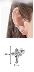 Macro detail of cross earring with purple zircon and hollow heart design measuring 1.19cm