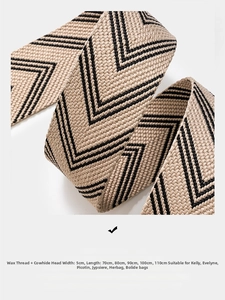 Detail of high-density herringbone woven bag strap with premium leather ends and 5cm width