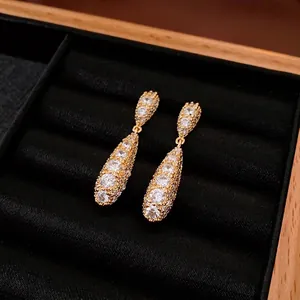 Luxurious gold-plated teardrop earrings with pave-set zircons in a premium jewelry box