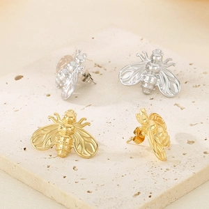 Minimalist bee shaped stainless steel stud earrings in gold and silver finishes