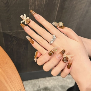 Handmade amber press-on nails in long coffin shape with 3D bows and pearls