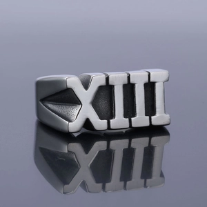 Polished silver stainless steel ring with XIII Roman numeral on gray background