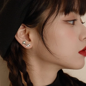 925 silver plated angel and devil wing stud earrings with opal stone on a female model