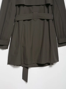 Detailed back view of dark olive windbreaker featuring waist belt and smooth fabric texture