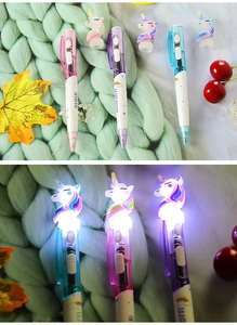 Glow-in-the-dark unicorn pens showing light-up LED effect and cute character design