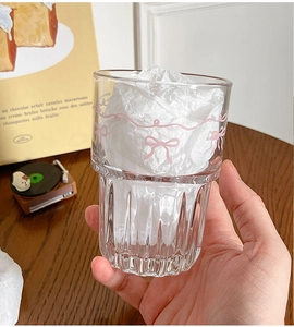 Close-up of pink bow design on a ribbed glass cup with a cute aesthetic and aesthetic vibes