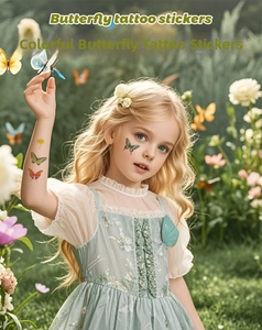 Close-up of colorful watercolor butterfly temporary tattoo stickers on a child skin