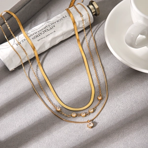 Elegant multi-layered gold stainless steel necklace featuring zircon pendants and snake chain