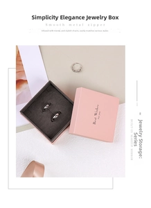 Pink jewelry box detail with inner velvet ring slots and a built-in makeup mirror