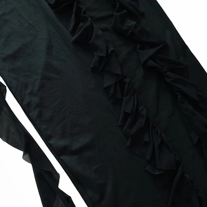 Detail of elegant black ruffles and delicate vertical gathers on the summer dress fabric