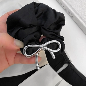 Elegant black satin scrunchie featuring a premium silver metal bow accent for women