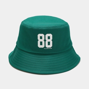 Close-up of green cotton bucket hat with white 88 print and stitched brim details