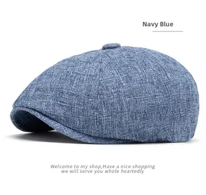 Close-up of navy blue newsboy cap showing textured linen blend fabric and top button detail