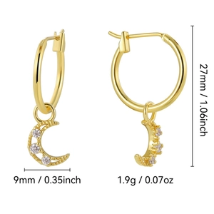 Gold-plated hoop earrings with hollow moon-shaped zircon pendants on white background