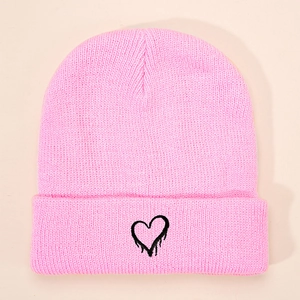 Pink knitted beanie hat for children with black embroidered heart pattern on center
