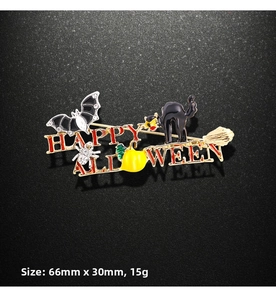 Detail showing Happy Halloween brooch dimensions 66mm by 30mm with enamel bat and pumpkin