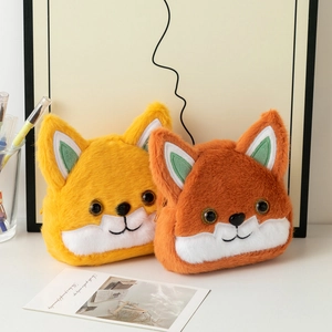 Close-up of cute plush fox coin pouches in yellow and orange with soft texture