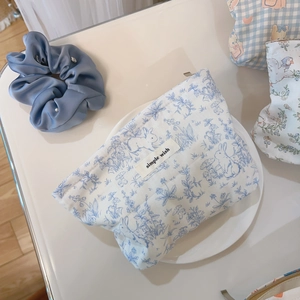 Close-up of blue rabbit pattern cotton cosmetic bag with 'simple wish' label in a tray