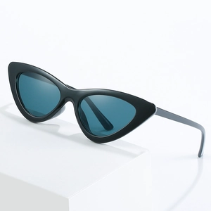 Classic black cat-eye sunglasses with blue lenses on a white geometric base