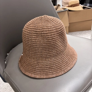 Close-up of a brown breathable knitted bucket hat with a fine textured weave pattern