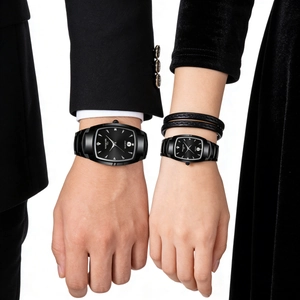 Close-up of couple wearing black tonneau quartz watches with calendar and matching bracelet
