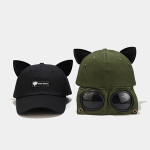 Detail view of cat ear baseball cap with integrated goggles and hand made label patch
