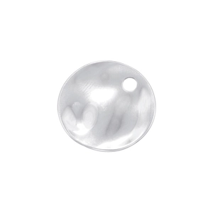 Macro detail of round silver metal pendant with hammered texture and small hole