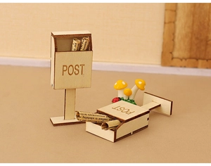 Detail of miniature wooden dollhouse mailboxes with POST engraving and tiny newspapers