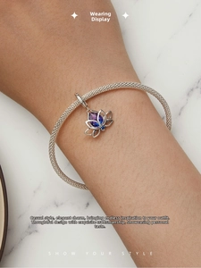 Detail of S925 silver mesh bracelet featuring a lotus pendant with gradient gemstones