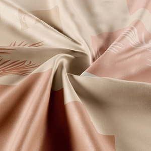 Close-up of bohemian tapestry fabric with geometric patterns and plant leaf silhouettes