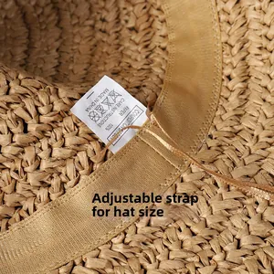 Detail of adjustable inner strap and 100% paper fiber material tag on straw sun hat