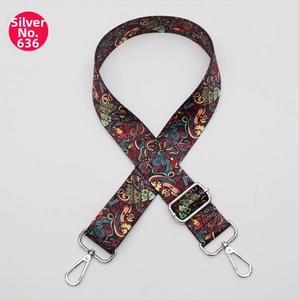 Detail of adjustable crossbody bag strap with colorful abstract graffiti and silver hooks