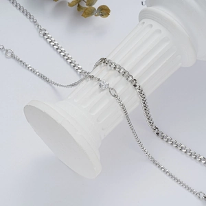 Elegant silver double-layer heart bracelet set on a white decorative pedestal