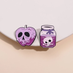 Detail of purple Halloween enamel pins featuring a skull poison apple and a potion bottle