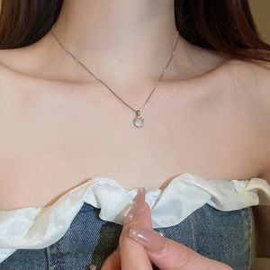 Minimalist cat eye stone pendant necklace on a delicate silver chain worn on the collarbone