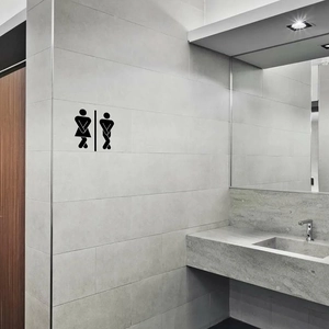 Detail of matte black waterproof male and female restroom sign on gray tile wall