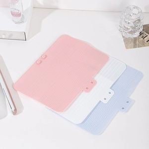 Portable silicone heat resistant mat for hair tools in pink, white and blue colors