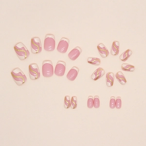Short ballet press-on nails with cream yellow French tips and golden glitter waves