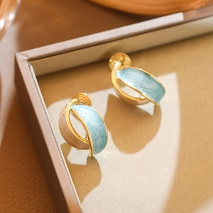 French vintage gold earrings with sky blue marble enamel in a cross hoop design
