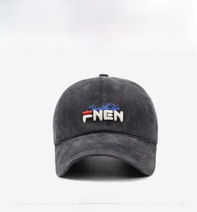 Detailed close-up of dark gray washed cotton baseball cap with 3D letter embroidery