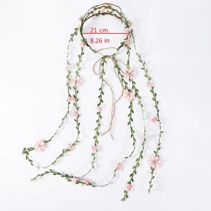 Detail view of pink floral rattan headband with 21cm diameter sizing and leaf vines
